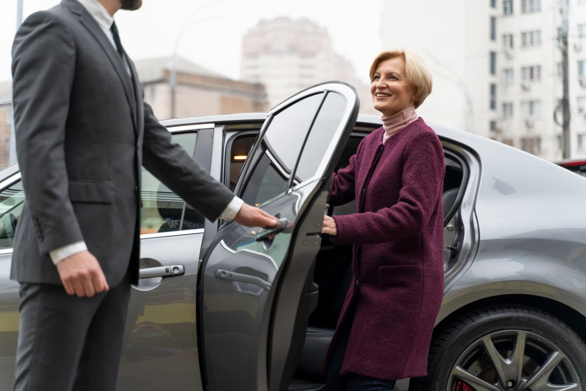 chauffeur opening door for executive