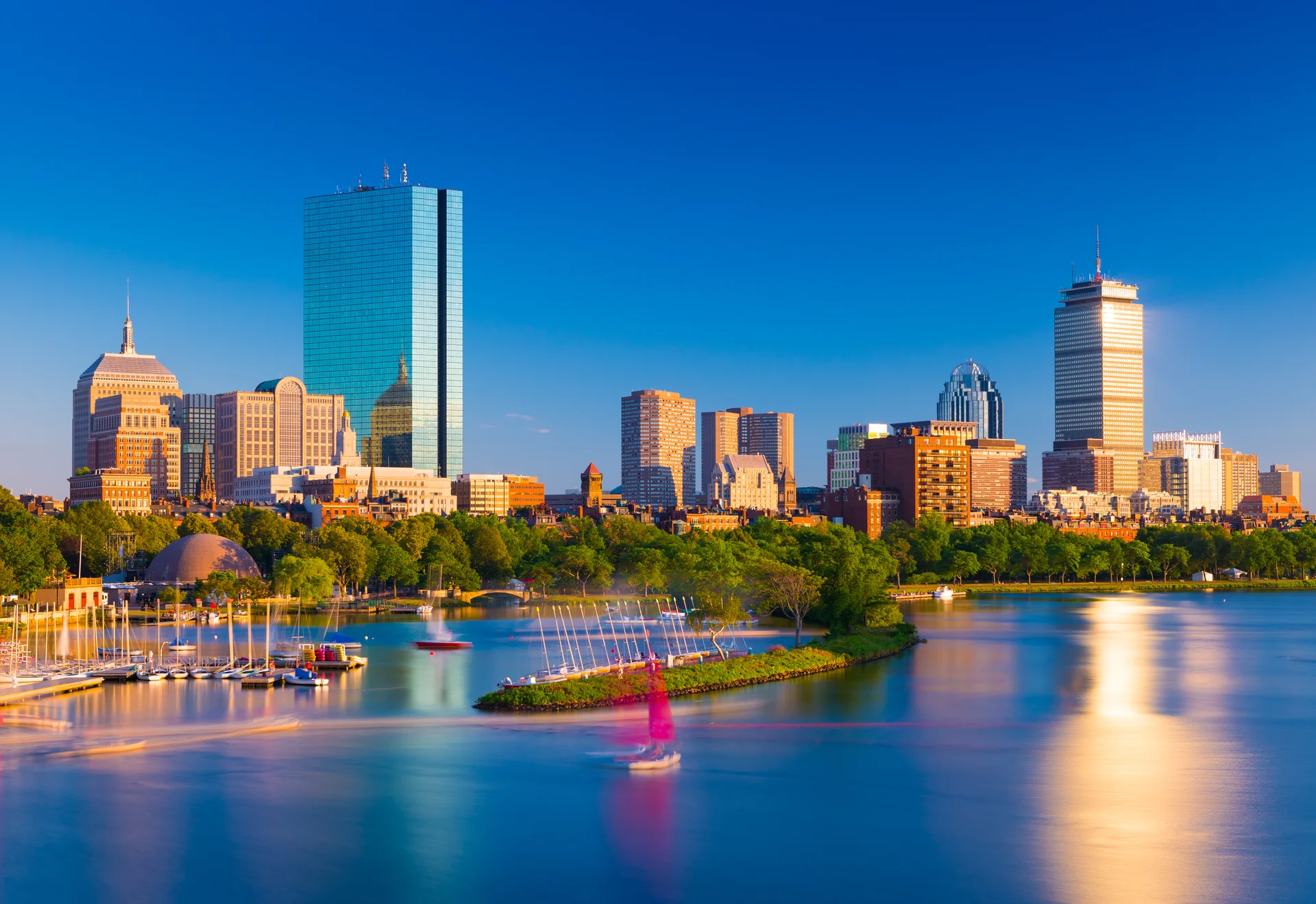 Luxury chauffeur service in Boston providing executive transportation with premium vehicles and professional drivers against iconic Boston skyline and historic architecture